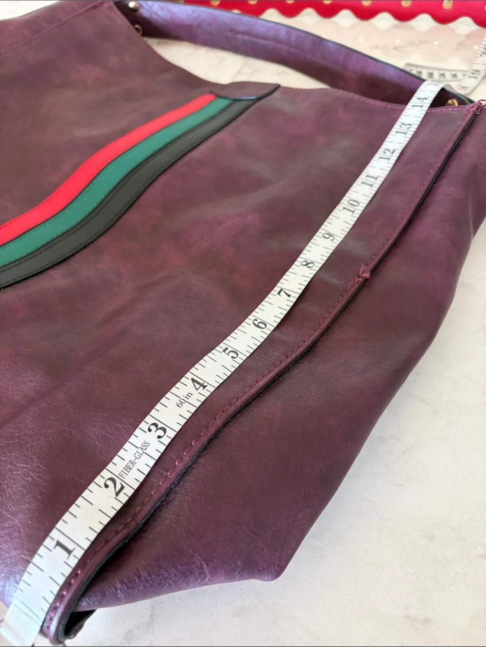 Large Burgundy leather bag with red and green accents